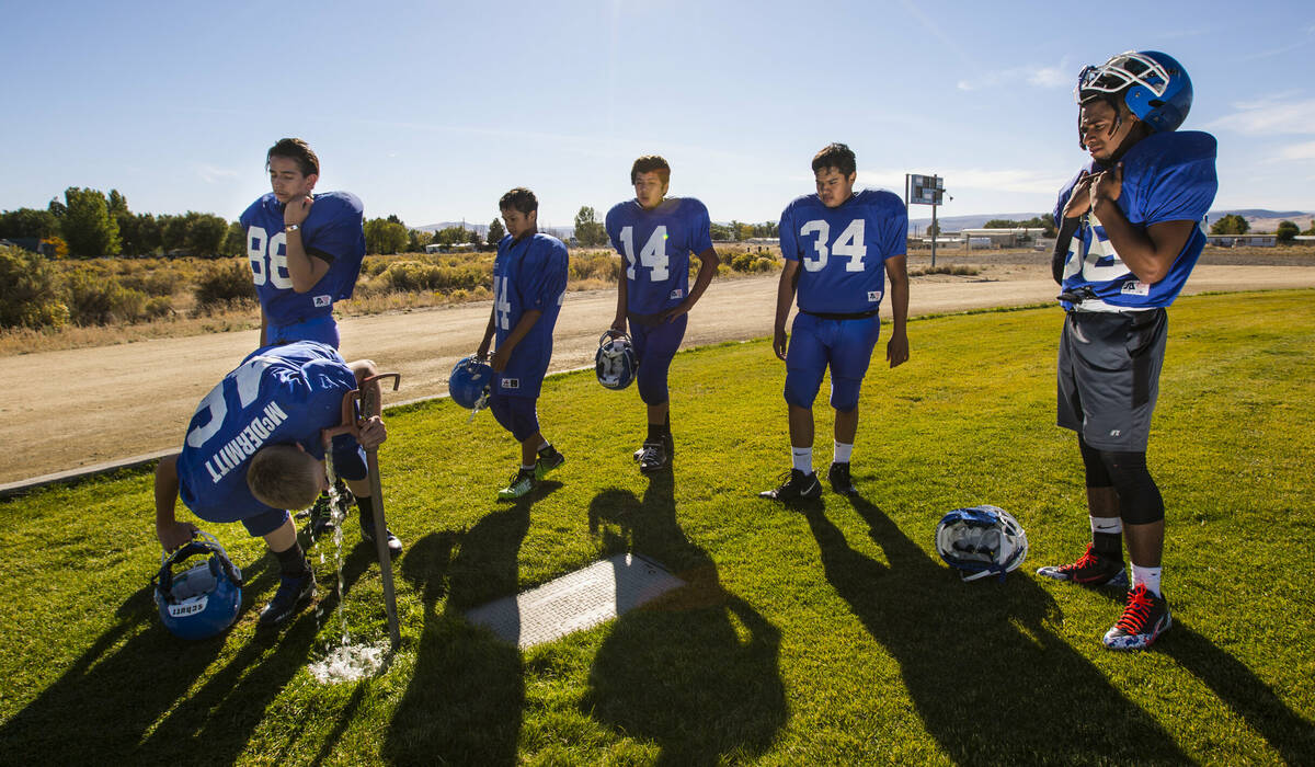 Football players hydrate during practice at McDermitt High School in McDermitt in 2018. (Chase ...