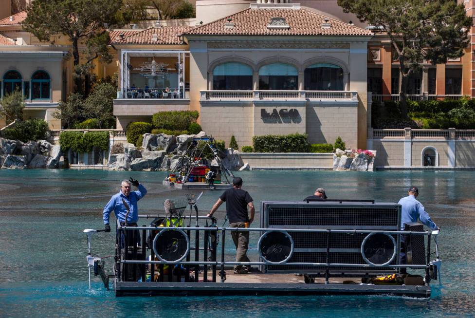 A boat crew cruises about the Bellagio Fountains as construction has started on the NFL red car ...