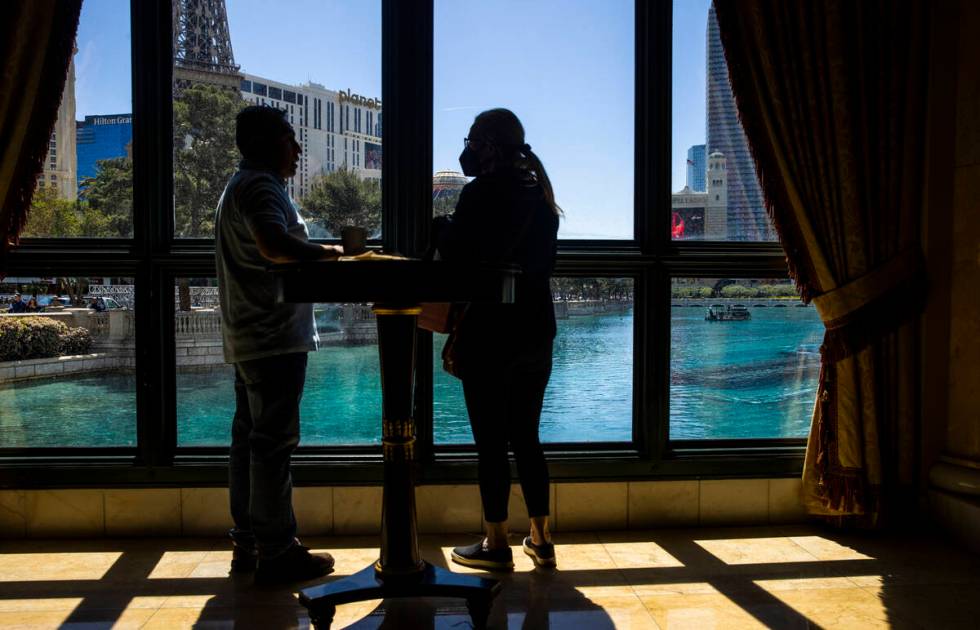 Visitors watch as divers and small boats take to the Bellagio Fountains as construction has sta ...