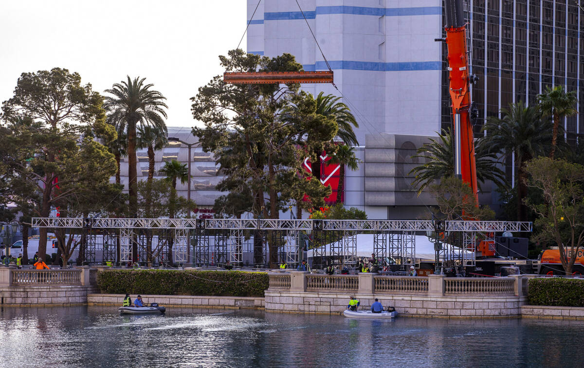 The first piece for the NFL Draft red carpet stage is lowered into place within the water at th ...