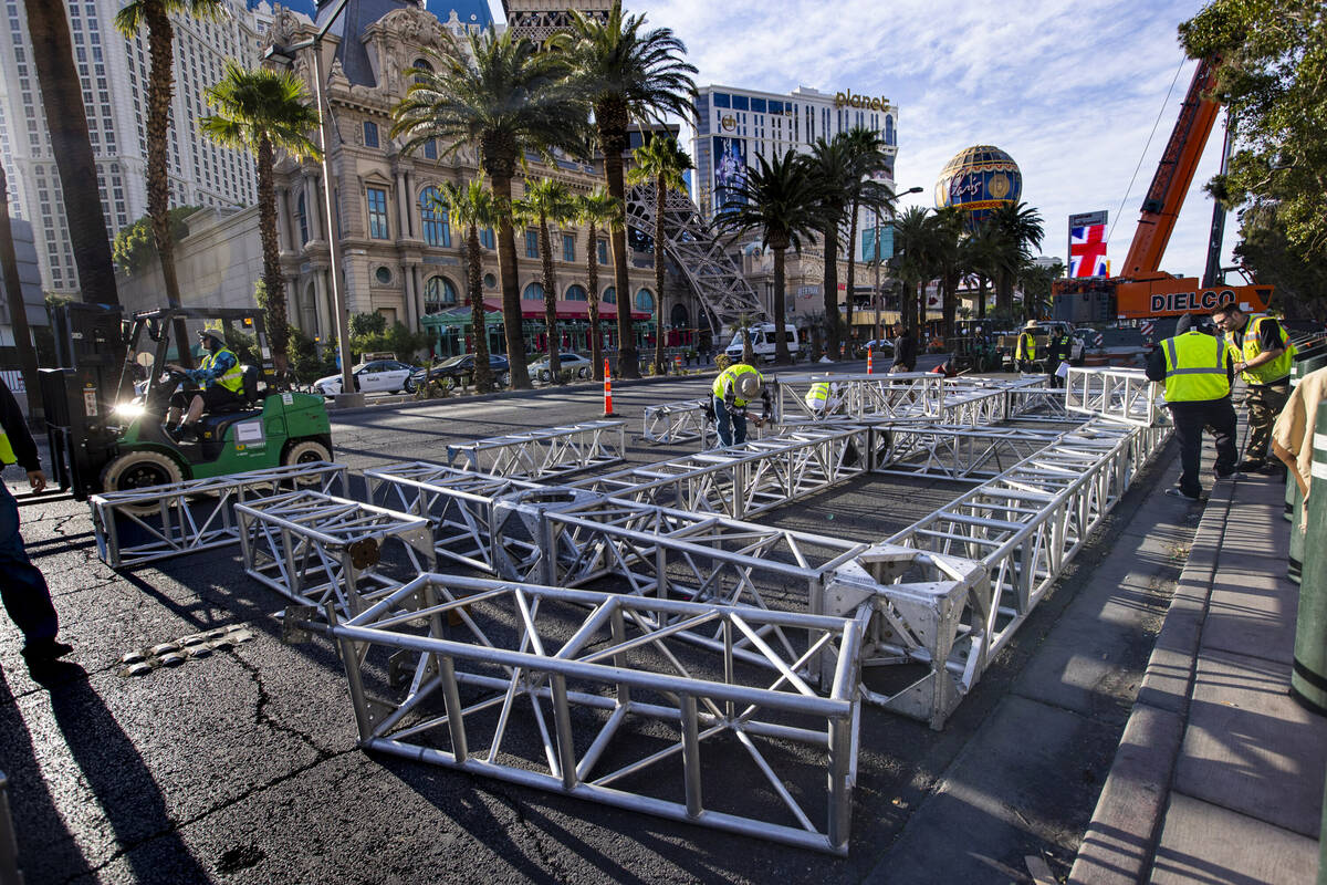 A construction crew assembles the second piece for the NFL Draft red carpet stage to be lowered ...