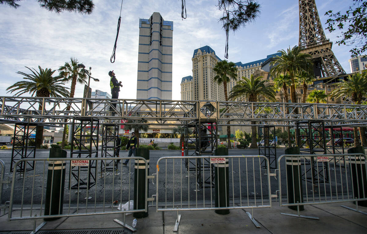 A construction crew readies to lift the second piece for the NFL Draft red carpet stage to be l ...