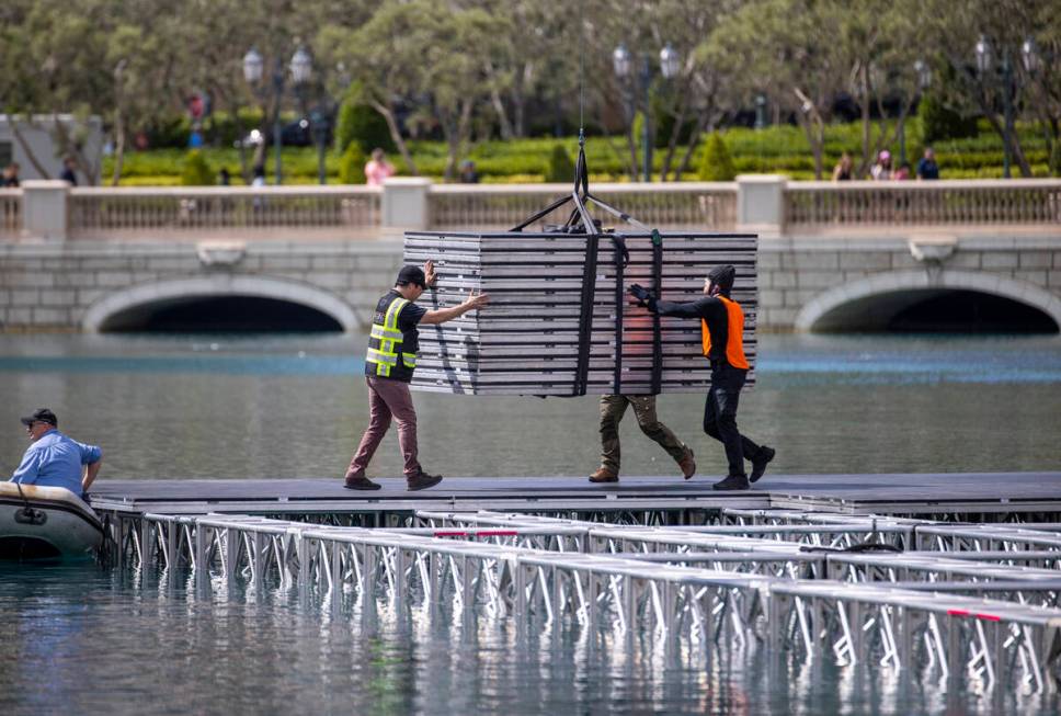 A construction crew lowers more flooring sections for the NFL Draft red carpet stage atop the w ...