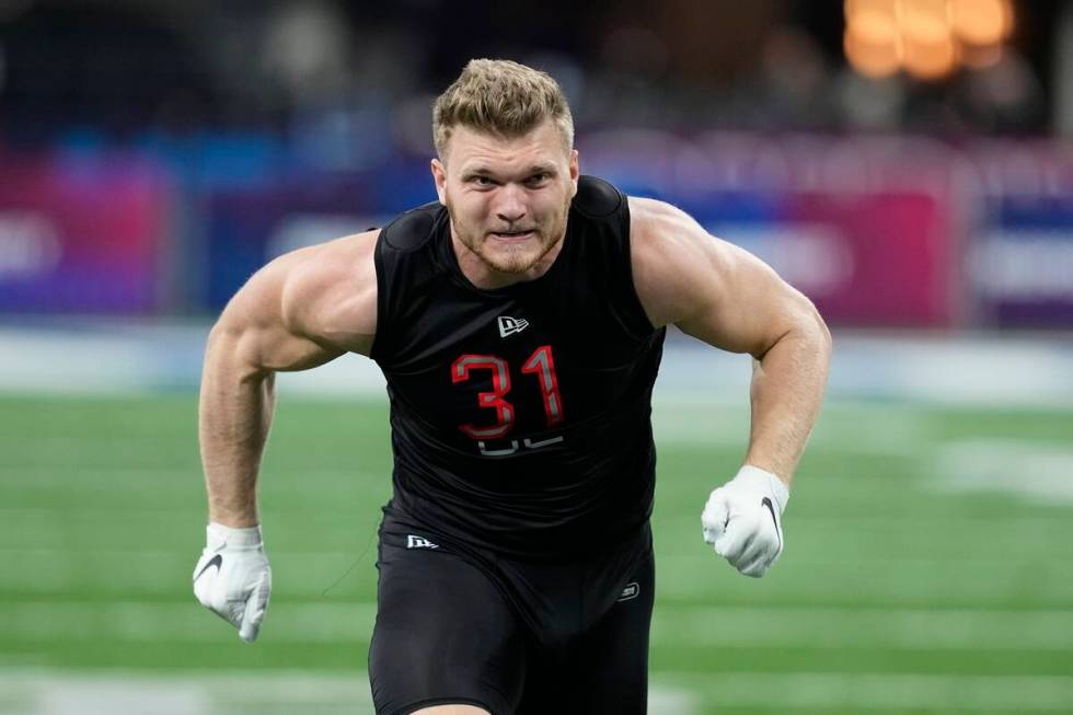 Michigan defensive lineman Aidan Hutchinson runs a drill during the NFL football scouting combi ...