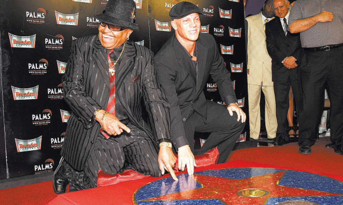 Joseph Jackson, left, father of the late Michael Jackson, touches his Brenden Celebrity Star af ...