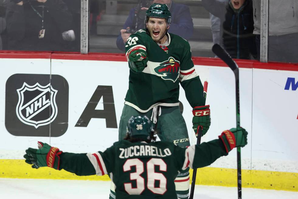 Minnesota Wild right wing Ryan Hartman (38) celebrates with teammate right wing Mats Zuccarello ...