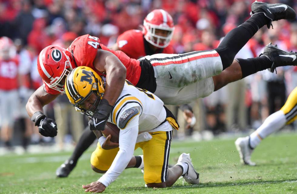 Missouri quarterback Tyler Macon (10) is sacked by Georgia's defensive lineman Travon Walker (4 ...