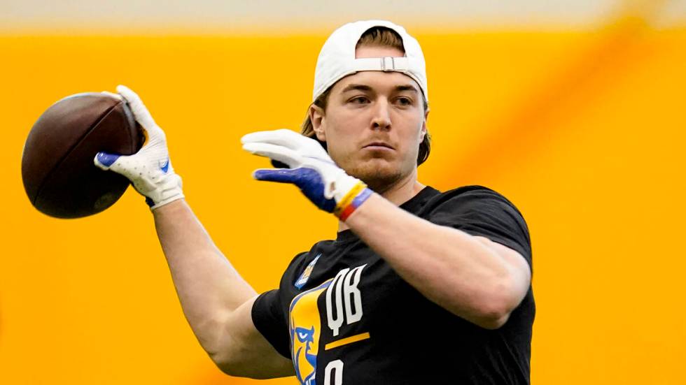 Pittsburgh quarterback Kenny Pickett (8) performs drills during Pittsburgh's football pro day , ...