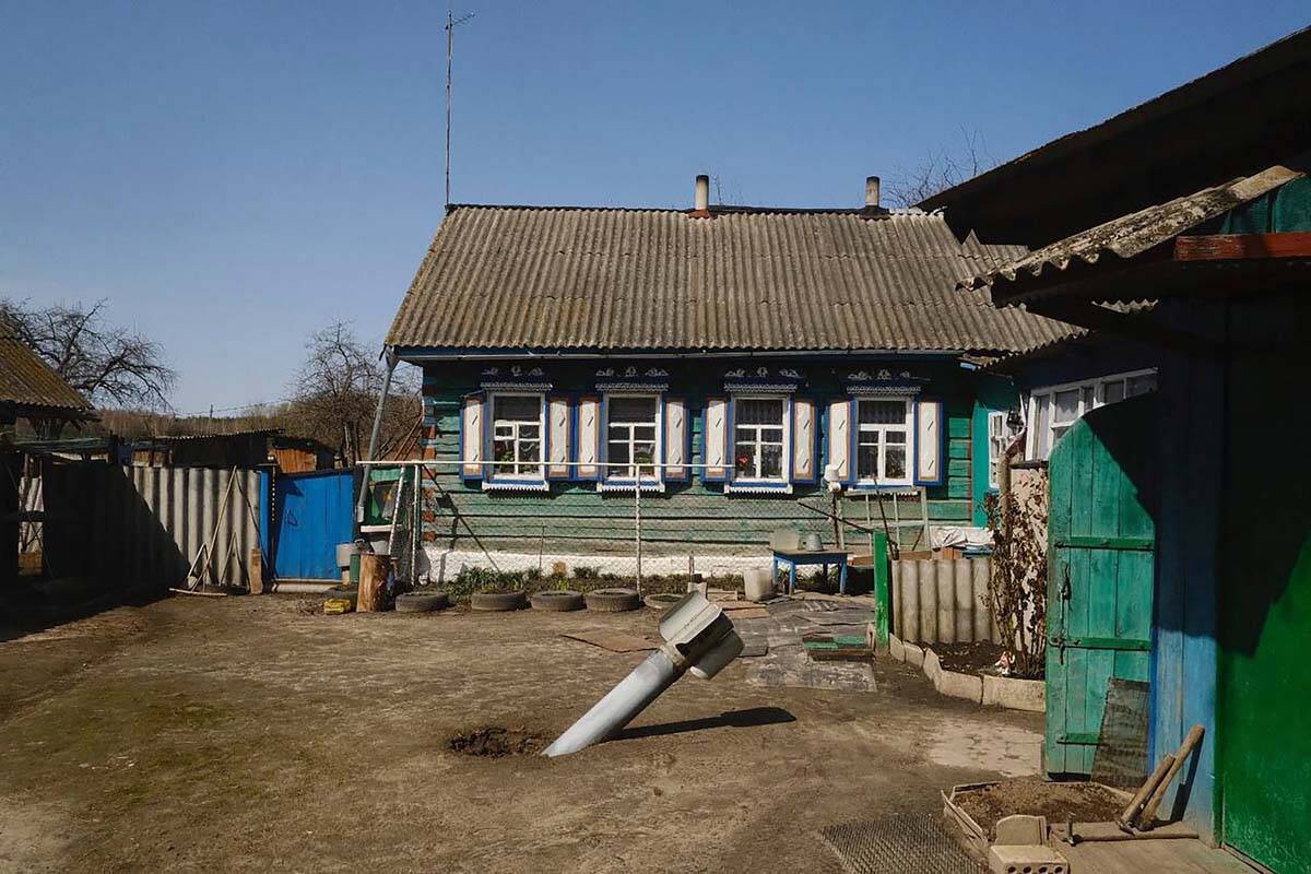 The tail of a missile in a yard of a residential area in a village of Senkivka, near the Belaru ...