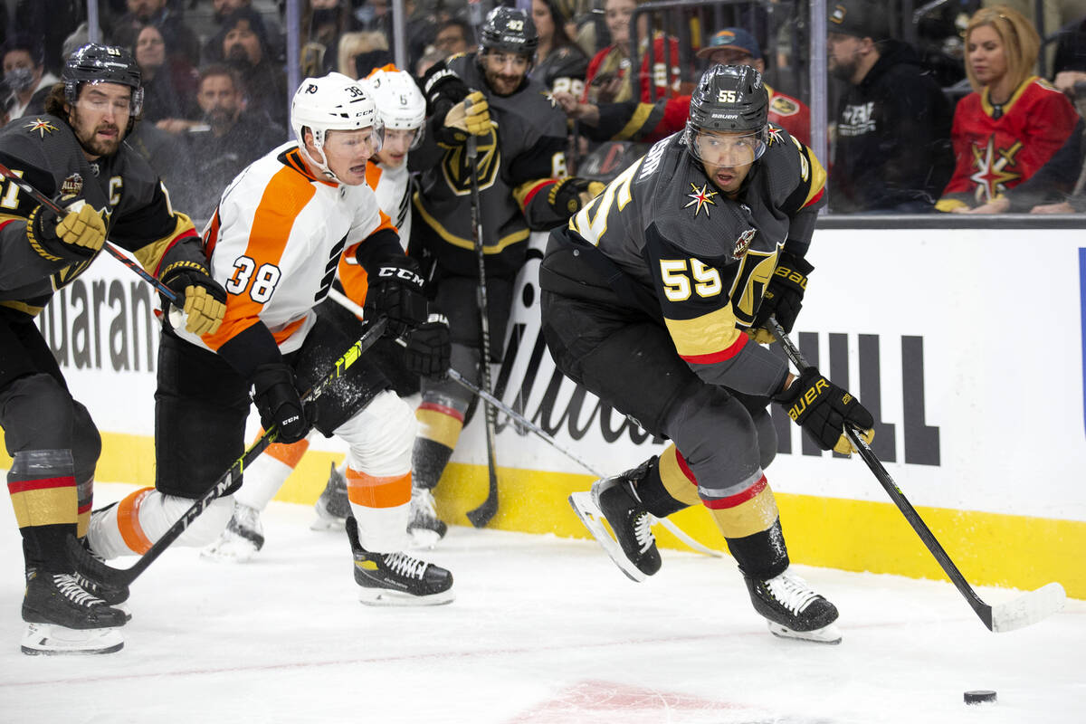 Golden Knights right wing Keegan Kolesar (55) skates with the puck followed by right wing Mark ...