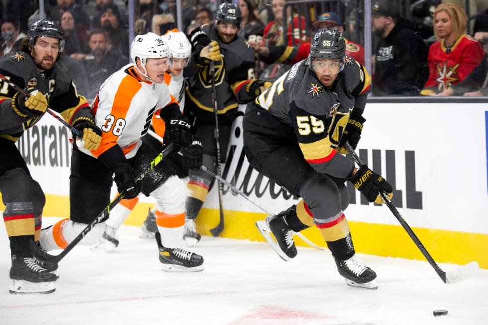 Golden Knights right wing Keegan Kolesar (55) skates with the puck followed by right wing Mark ...