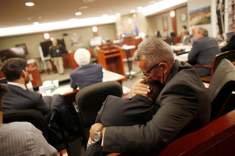 FILE - Gavin Cox holds his wife Minh-Hahn Cox as they wait for the jury's decision in his trial ...