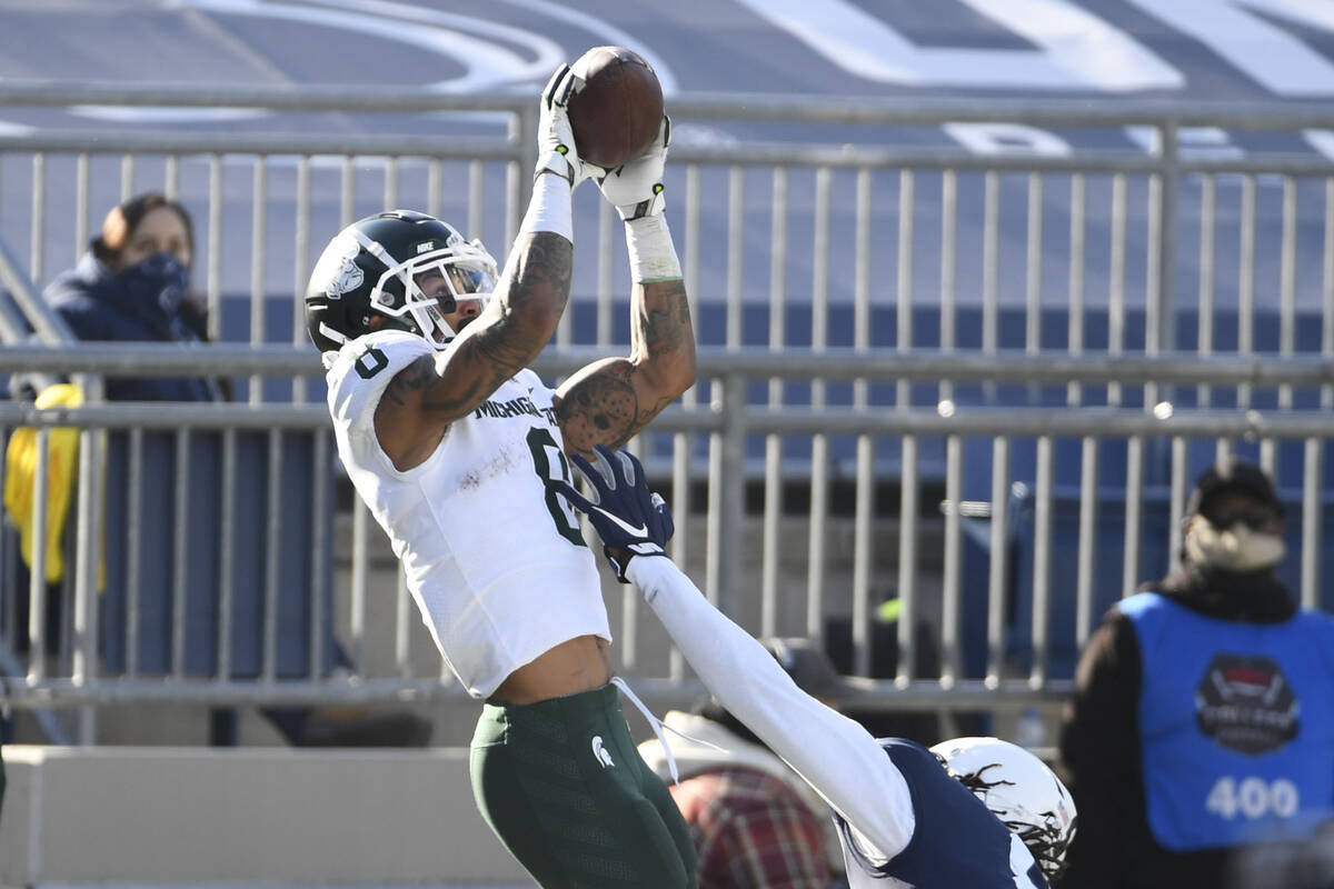 Michigan State wide receiver Jalen Nailor (8) catches a touchdown pass over Penn State cornerba ...