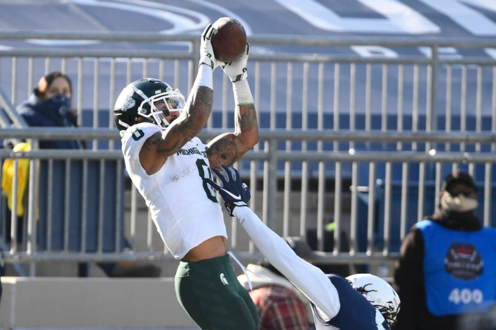 Michigan State wide receiver Jalen Nailor (8) catches a touchdown pass over Penn State cornerba ...