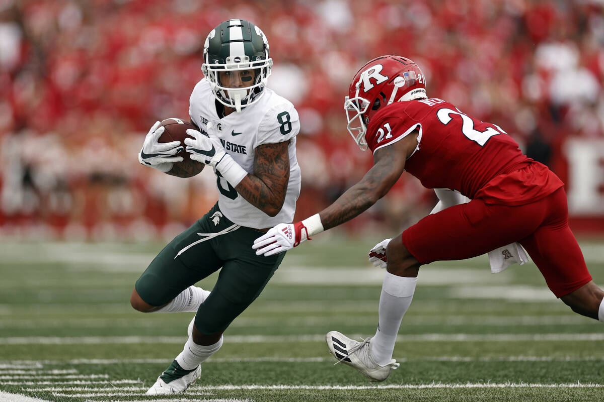 Michigan State wide receiver Jalen Nailor (8) is forced out of bounds by Rutgers defensive back ...