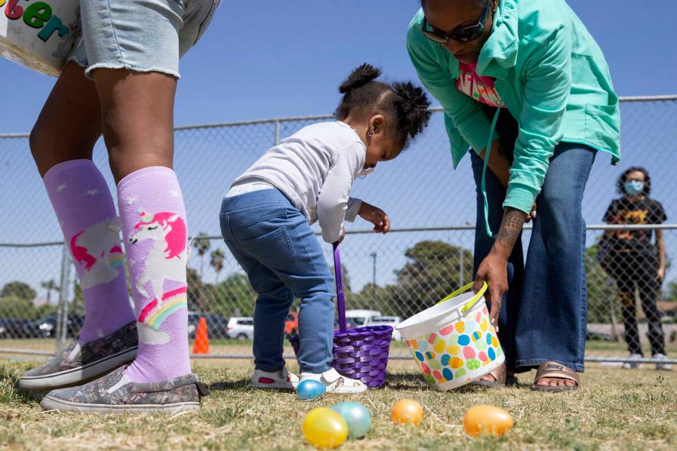 Jeanine Hall, right, helps her daughter Kieren Hall, 2, hunt for eggs during the Egg-Apalooza E ...