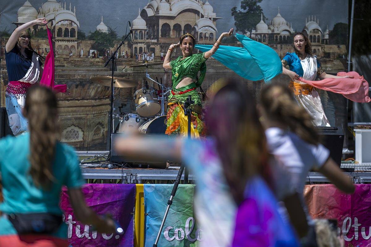 Dancers perform as the crowd joins in at the Holi Festival of Colors at Sunset Park on Saturday ...