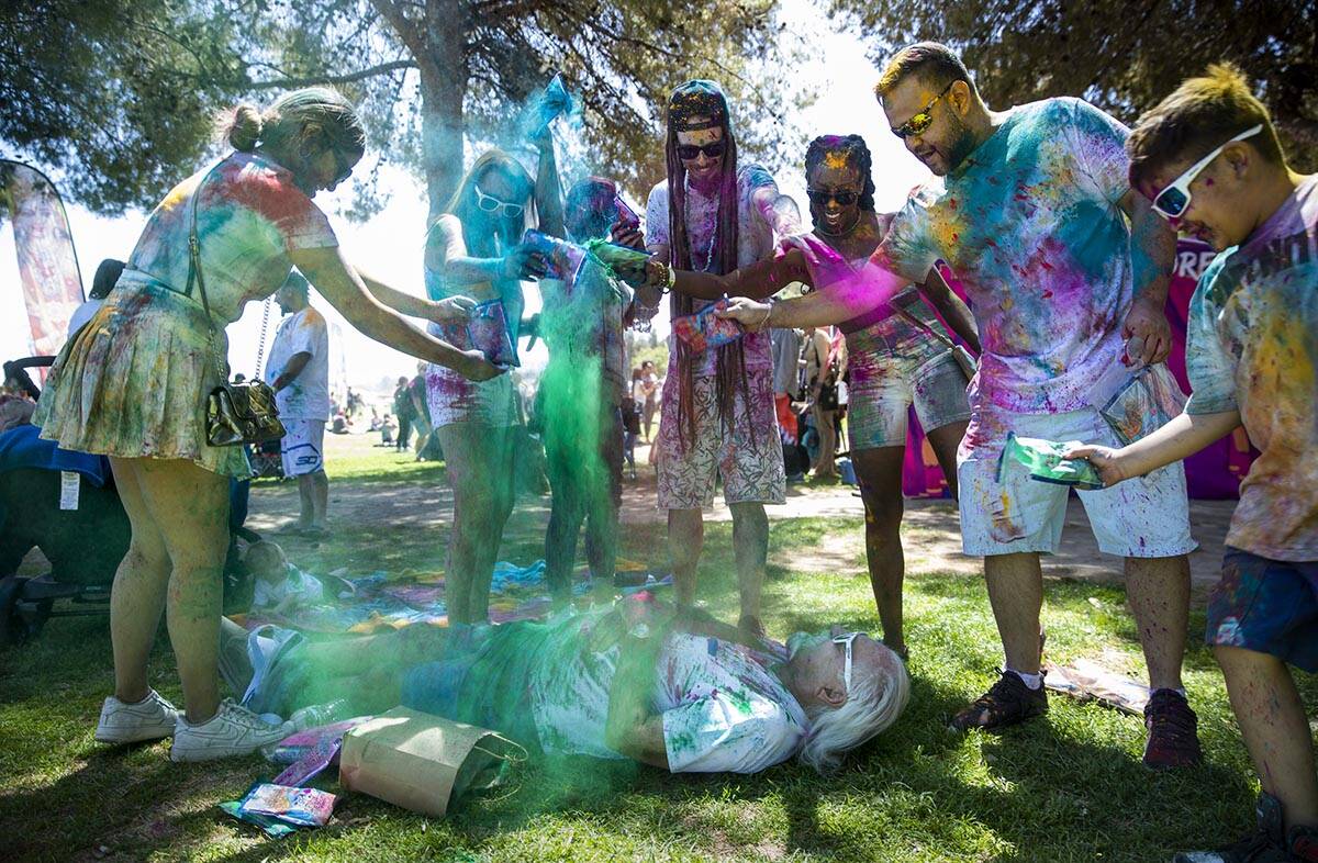 Larry Turner of Yuma, Arizona, is doused with colors while napping by friends and family on his ...