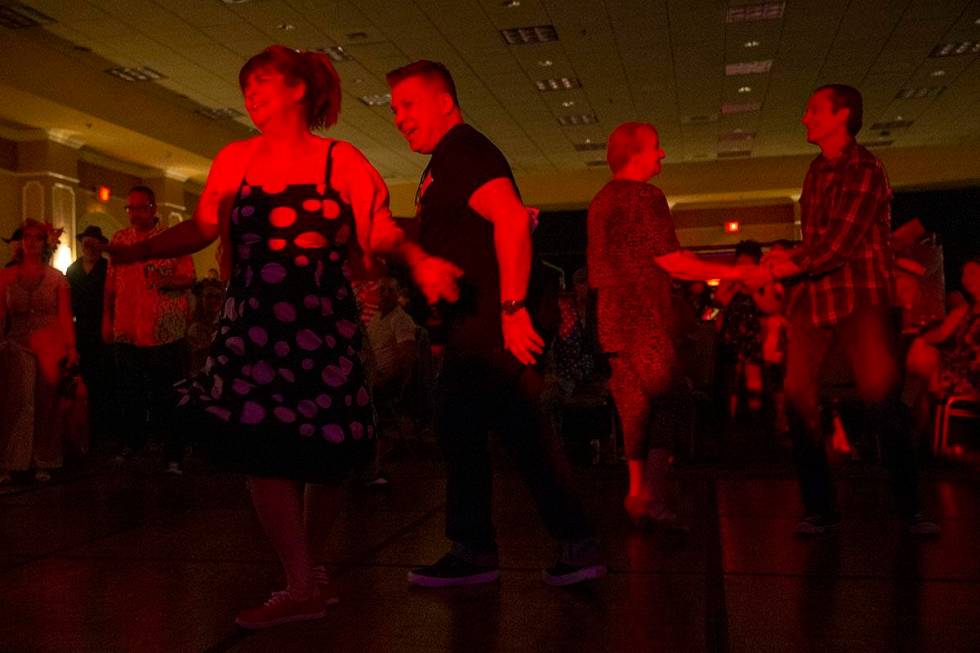 Sally Janssens, left, and Gerry Laureys, second from left, of Belgium, swing dance during Shand ...