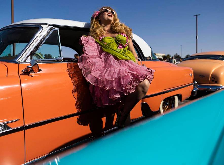 Jody Collins, from Sacramento, Calif., takes photos with a classic car during the Rockabilly Ca ...