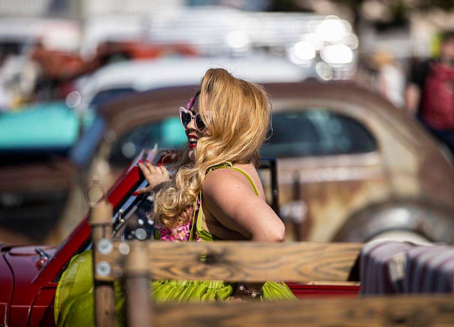 Jody Collins, from Sacramento, Calif., takes pictures with classic cars during the Rockabilly C ...
