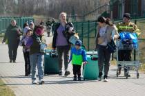 Refugees walk at the border crossing in Medyka, southeastern Poland, after fleeing the war from ...
