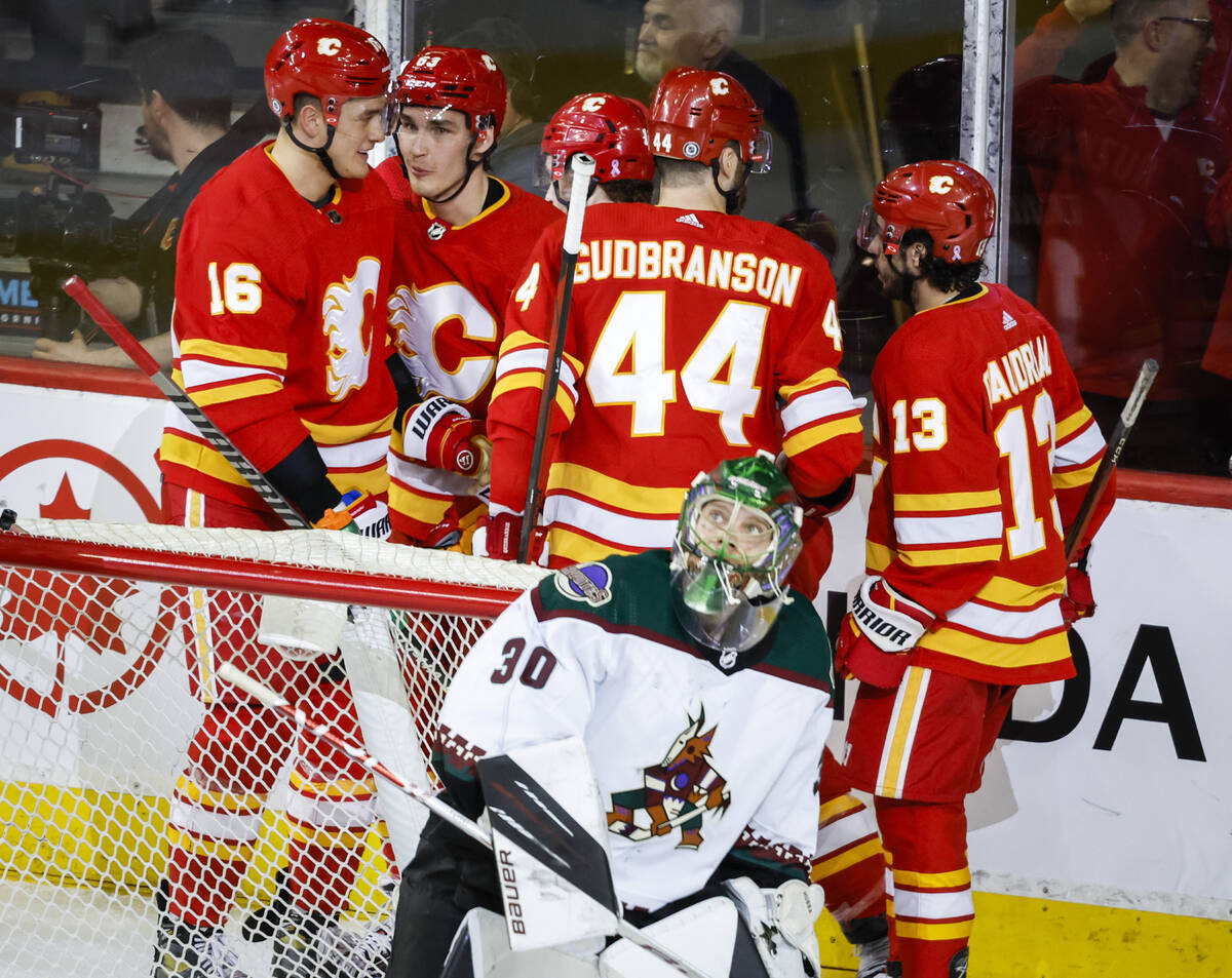 Arizona Coyotes goalie Harri Sateri (30) looks to the scoreboard as Calgary Flames celebrate a ...