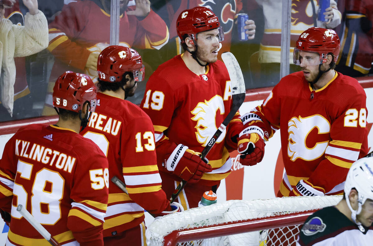 Calgary Flames' Matthew Tkachuk, second from right, celebrates his goal against the Arizona Coy ...