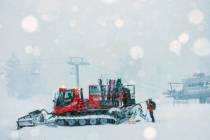 Crew members get ready to board a snow plowe in Mammoth Mountain in Mammoth Lakes, Calif., on F ...