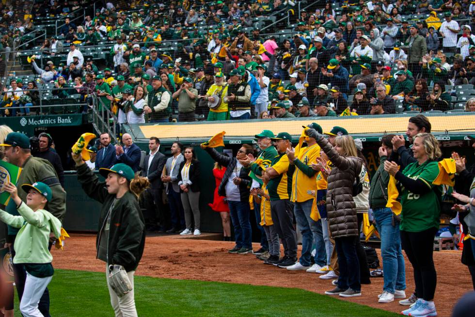 Oakland Athletics fans cheer before the opening night game against the Baltimore Orioles on Mon ...