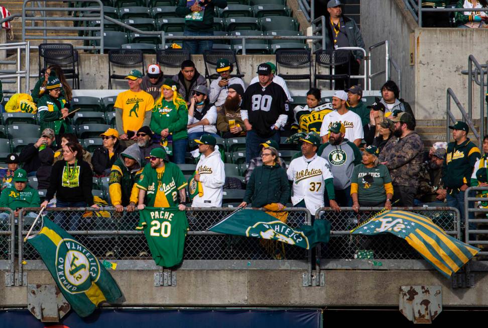 Oakland Athletics fans stand for the national anthem before the opening night game against the ...