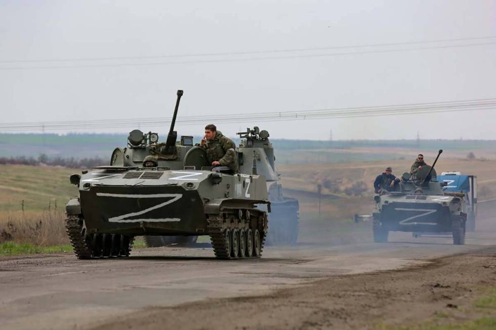 Russian military vehicles move on a highway in an area controlled by Russian-backed separatist ...