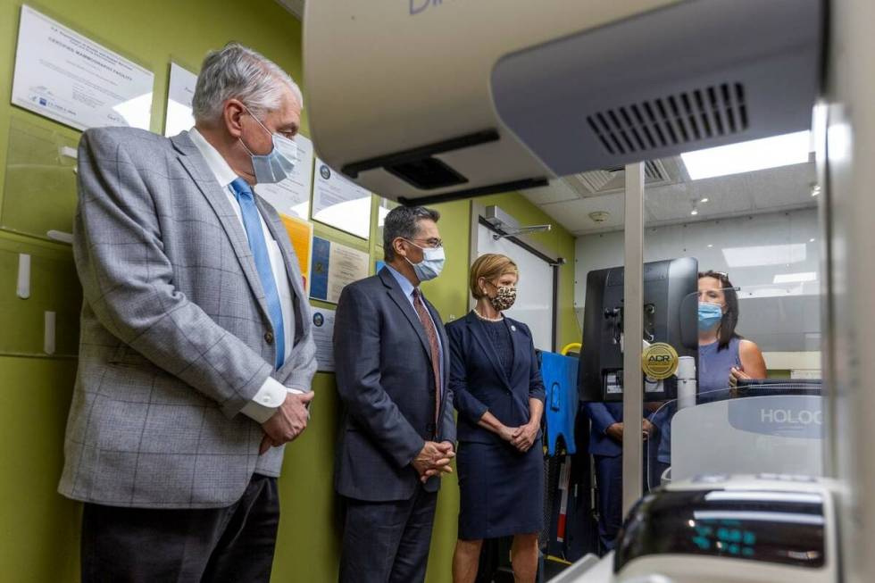 From left, Gov. Steve Sisolak, HHS Secretary Xavier Becerra and Rep. Susie Lee listen to Rhonda ...