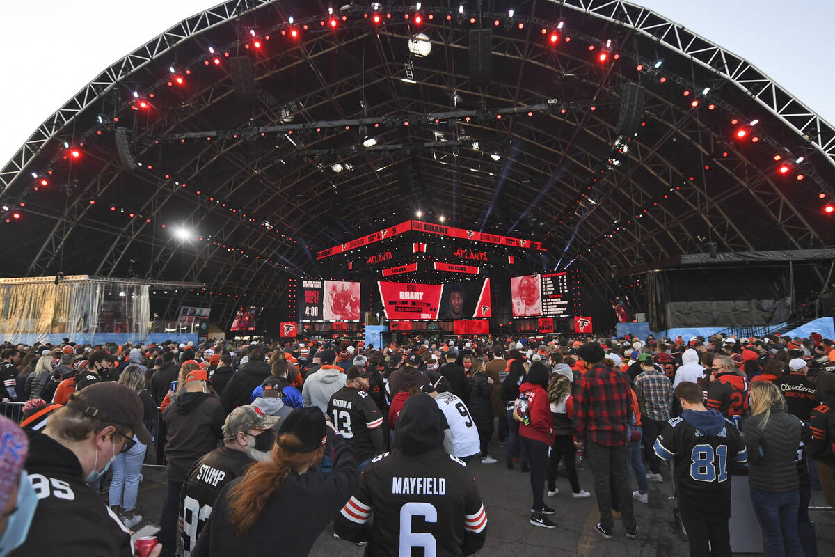 Fans watch the from the outside of the NFL Draft Theatre during the second round of the NFL foo ...