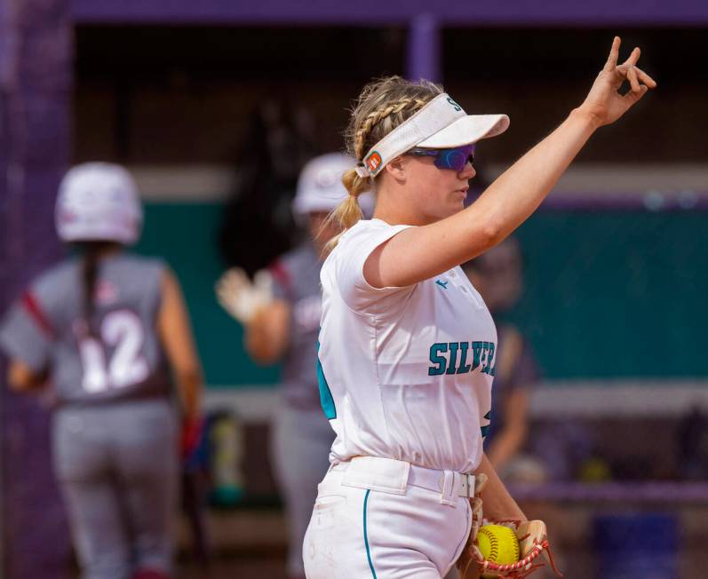 Silverado’s Macy Magdaleno (21) signals two outs during a girls high school softball gam ...