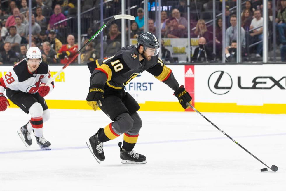 Golden Knights center Nicolas Roy (10) breaks away from New Jersey Devils defenseman Damon Seve ...