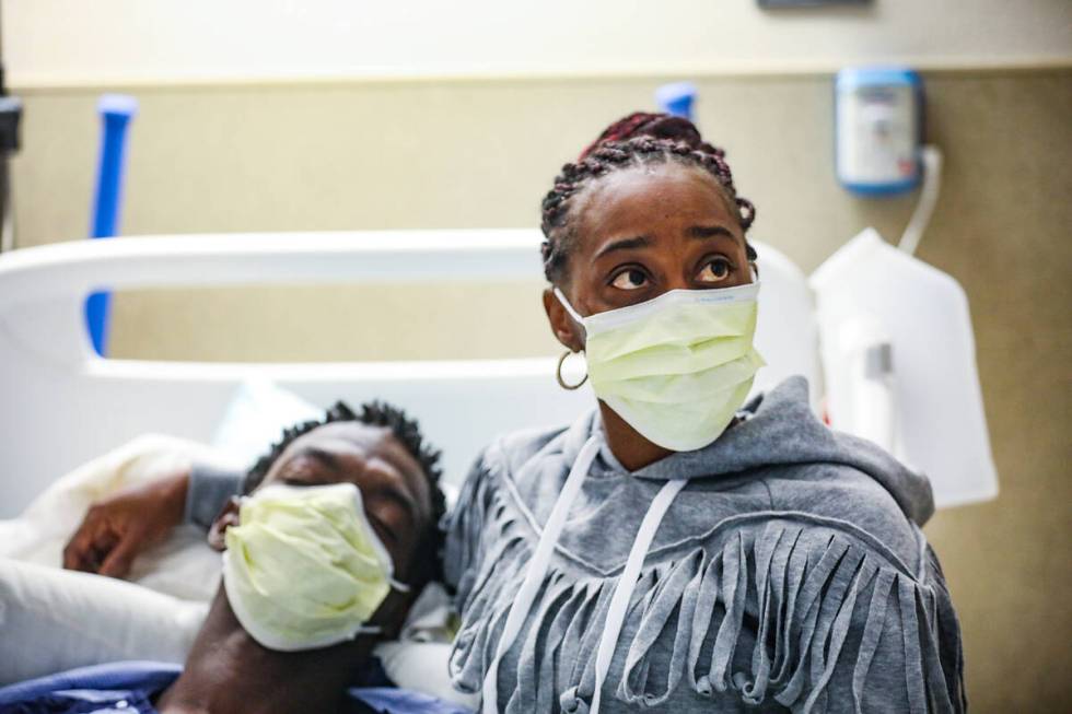 Derek McMillan, left, with his wife Darshelle McMillan, right, speak to the Review-Journal abou ...