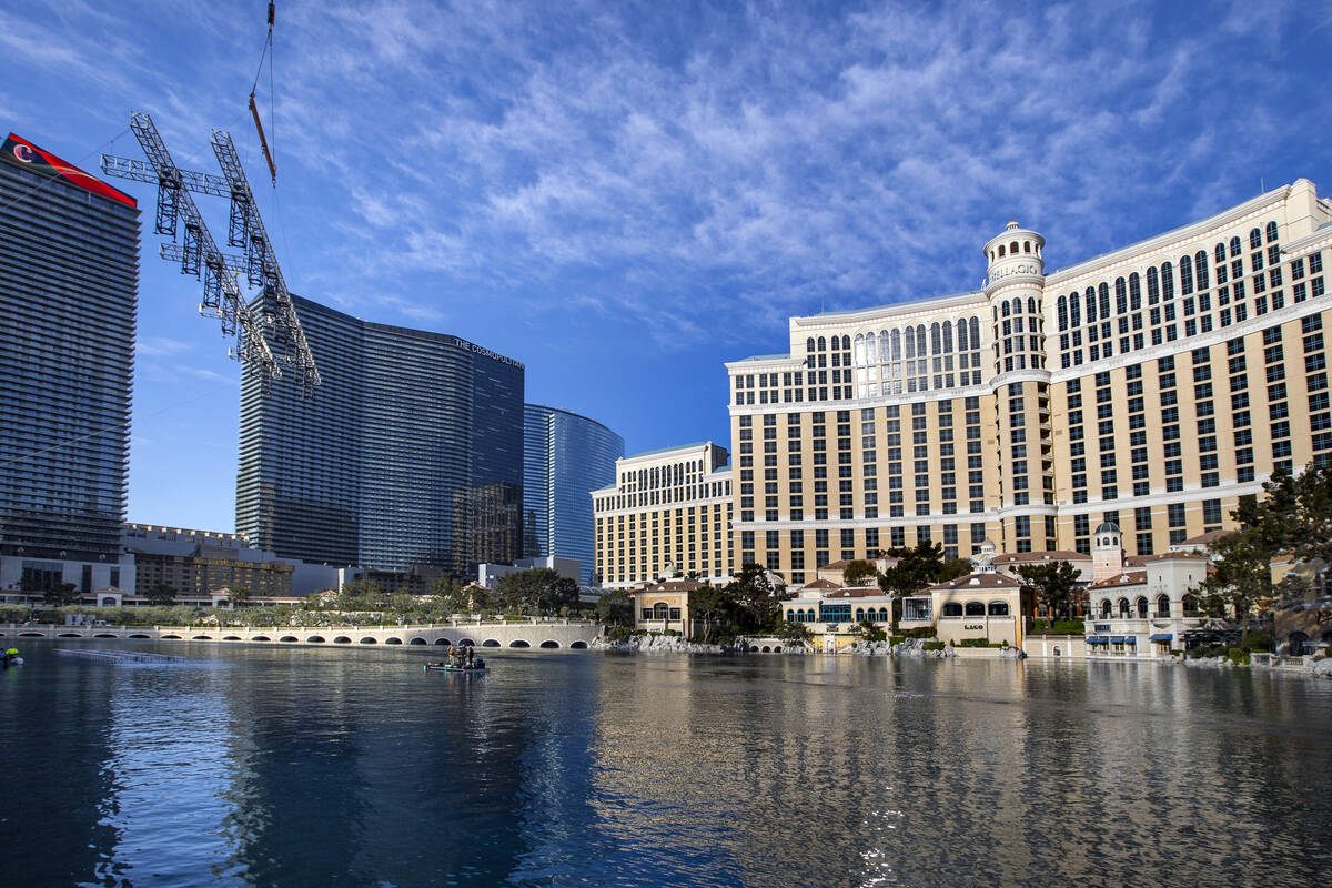 The second piece for the NFL red carpet draft stage is lowered onto the water at the Bellagio F ...