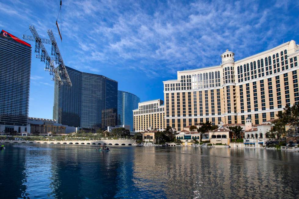The second piece for the NFL red carpet draft stage is lowered onto the water at the Bellagio F ...