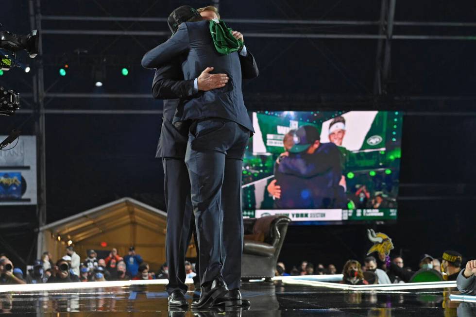 BYU quarterback Zach Wilson, right, hugs NFL Commissioner Roger Goodell after the New York Jets ...