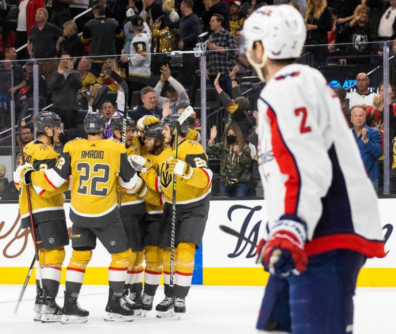 Golden Knights players celebrate a goal by teammate Alec Martinez (23) in the first period duri ...