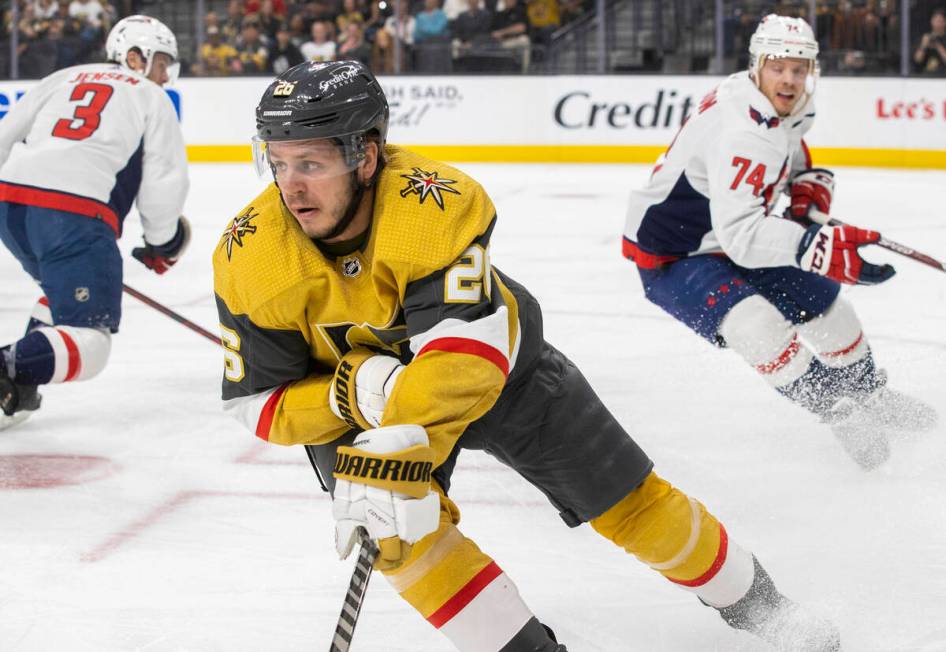 Golden Knights center Mattias Janmark (26) pushes the puck up ice with Washington Capitals defe ...