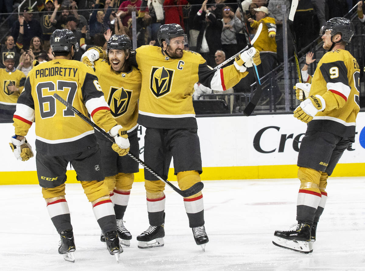 Golden Knights center Chandler Stephenson (20) celebrates with Golden Knights right wing Mark S ...