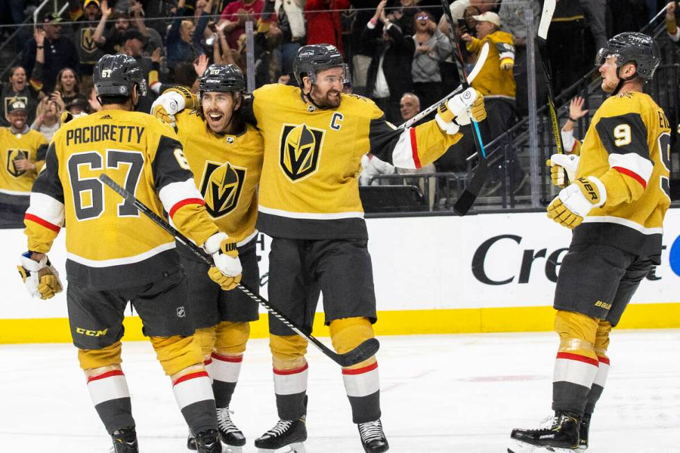 Golden Knights center Chandler Stephenson (20) celebrates with Golden Knights right wing Mark S ...