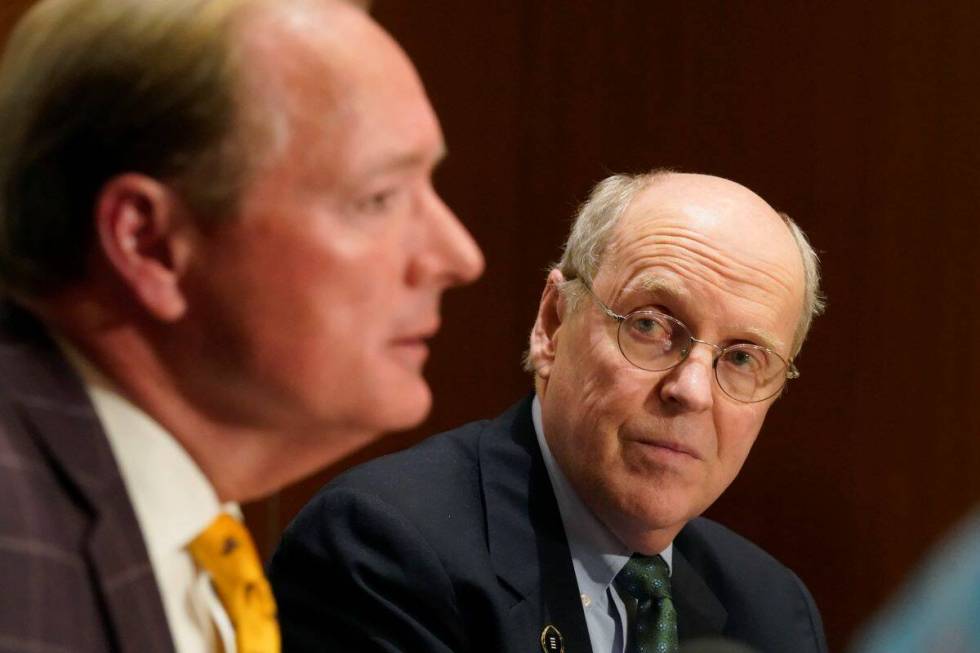 College Football Playoff Executive Director Bill Hancock, right, looks on as Mark Keenum, Missi ...