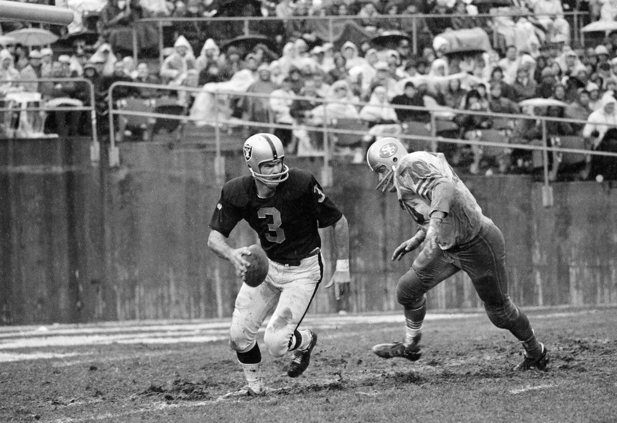 Oakland Raiders quarterback Daryle Lamonica (3) hustles to get out of the path of Charley Kreug ...
