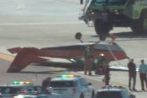 A small plane flipped over at Harry Reid International Airport on Thursday morning with two peo ...