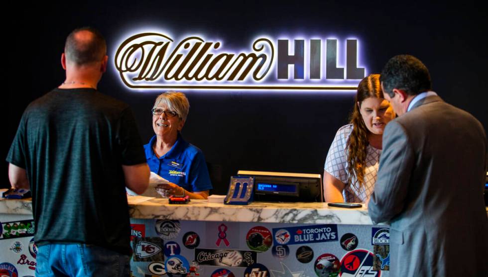 In this April 15, 2019, file photo, customers place their wagers at the William Hill Sports Boo ...