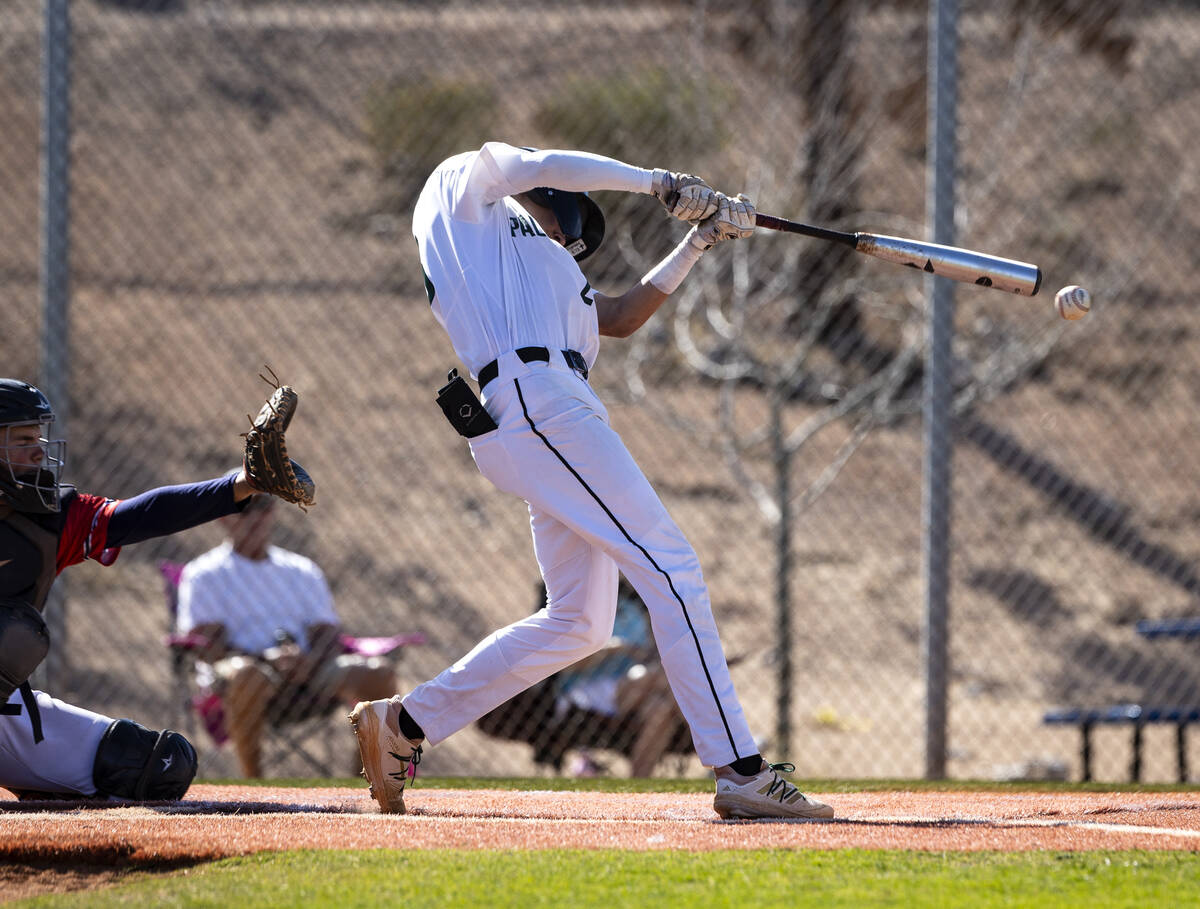 Palo High’s shortstop Ethan Clauss (23) makes contact during the second innings of a boy ...