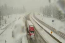 A truck makes its way past the snow along Interstate 80 near Highway 267 in Truckee, Calif., on ...